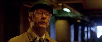 Movie still from “North Country” (2005), directed by Niki Caro – An older man wearing glasses and a green hat; Close Up shot, Low angle