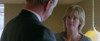 Movie still from “North Country” (2005), directed by Niki Caro – A man and a woman looking at each other in a mirror; Close Up shot, Over the shoulder angle