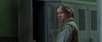 Movie still from “North Country” (2005), directed by Niki Caro – A woman standing in front of a metal door; Close Up shot, Low angle