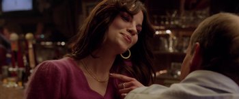 Movie still from “North Country” (2005), directed by Niki Caro – A beautiful young lady with long brown wavy hair; Close Up shot, Over the shoulder angle