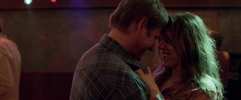 Movie still from “North Country” (2005), directed by Niki Caro – A man and a woman smiling at each other; Close Up shot, Over the shoulder angle