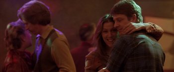 Movie still from “North Country” (2005), directed by Niki Caro – A man and a woman are hugging in a room; Medium shot, Over the shoulder angle