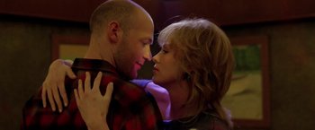 Movie still from “North Country” (2005), directed by Niki Caro – A man and a woman are kissing in a room; Close Up shot, Over the shoulder angle