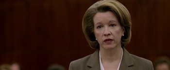 Movie still from “North Country” (2005), directed by Niki Caro – A person wearing a suit and tie; Close Up shot, Low angle