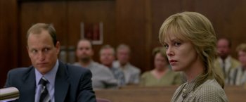 Movie still from “North Country” (2005), directed by Niki Caro – A woman standing in front of a group of people in a courtroom; Close Up shot, Over the shoulder angle