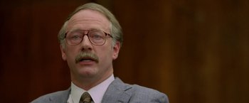 Movie still from “North Country” (2005), directed by Niki Caro – An older man in a suit and tie; Close Up shot, Low angle