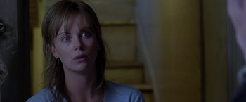 Movie still from “North Country” (2005), directed by Niki Caro – A person sitting on stairs; Close Up shot, Low angle