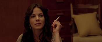 Movie still from “North Country” (2005), directed by Niki Caro – A woman is holding a cigarette in her hand; Close Up shot, Over the shoulder angle