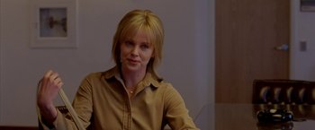 Movie still from “North Country” (2005), directed by Niki Caro – A woman with blonde hair wearing a brown shirt; Close Up shot, Over the shoulder angle