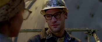 Movie still from “North Country” (2005), directed by Niki Caro – A person wearing glasses and a hard hat; Close Up shot, Low angle