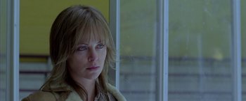 Movie still from “North Country” (2005), directed by Niki Caro – A person wearing a jacket near a window; Close Up shot, Low angle