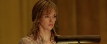 Movie still from “North Country” (2005), directed by Niki Caro – A person wearing a plaid shirt; Close Up shot, Low angle