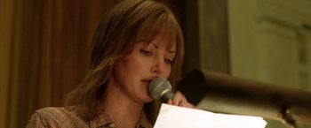 Movie still from “North Country” (2005), directed by Niki Caro – A woman holding a microphone up to her mouth; Close Up shot, Low angle