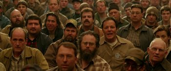 Movie still from “North Country” (2005), directed by Niki Caro – A large group of men standing in front of each other; Medium shot, High angle