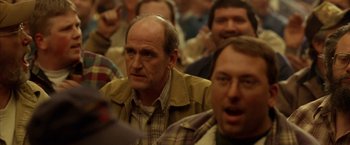 Movie still from “North Country” (2005), directed by Niki Caro – A group of people sitting in a room; Close Up shot, Over the shoulder angle