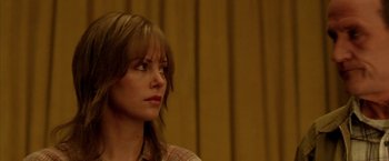 Movie still from “North Country” (2005), directed by Niki Caro – A person wearing a plaid shirt; Close Up shot, Over the shoulder angle