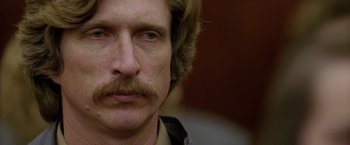 Movie still from “North Country” (2005), directed by Niki Caro – A person with a mustache; Close Up shot, Low angle
