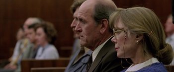 Movie still from “North Country” (2005), directed by Niki Caro – A man and two women sitting in a court room; Close Up shot, Over the shoulder angle