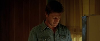 Movie still from “North Country” (2005), directed by Niki Caro – A person wearing a jean shirt; Close Up shot, Low angle