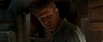 Movie still from “North Country” (2005), directed by Niki Caro – A person wearing a jean shirt; Close Up shot, Low angle