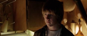 Movie still from “North Country” (2005), directed by Niki Caro – A young man is looking into the camera; Close Up shot, Over the shoulder angle