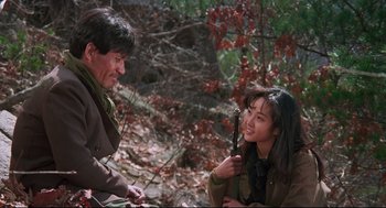 Movie still from “North Korean Partisan in South Korea” (1990), directed by Jeong Ji-yeong – A man and a woman are talking in the woods; Medium shot, High angle
