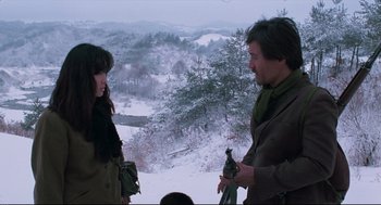 Movie still from “North Korean Partisan in South Korea” (1990), directed by Jeong Ji-yeong – A man and a woman standing on top of a hill; Medium shot, Over the shoulder angle