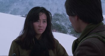 Movie still from “North Korean Partisan in South Korea” (1990), directed by Jeong Ji-yeong – A woman in a brown jacket and a man in a brown jacket; Close Up shot, Over the shoulder angle