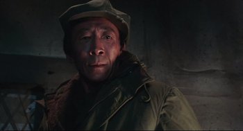 Movie still from “North Korean Partisan in South Korea” (1990), directed by Jeong Ji-yeong – A man wearing a hat and a jacket; Close Up shot, Low angle