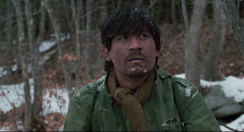 Movie still from “North Korean Partisan in South Korea” (1990), directed by Jeong Ji-yeong – A man in a green jacket and a scarf; Close Up shot, Over the shoulder angle