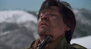 Movie still from “North Korean Partisan in South Korea” (1990), directed by Jeong Ji-yeong – A person holding a pipe in his mouth; Close Up shot, Low angle
