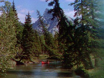 Movie still from “North West Mounted Police” (1940), directed by Cecil B. DeMille – A red canoe on the water; Extreme Wide shot, High angle
