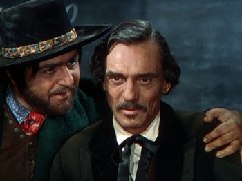 Movie still from “North West Mounted Police” (1940), directed by Cecil B. DeMille – A man with a beard and a hat and a man with a beard and a hat; Close Up shot, Over the shoulder angle