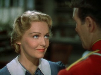 Movie still from “North West Mounted Police” (1940), directed by Cecil B. DeMille – A woman in a white blouse is looking at a man in a red jacket; Close Up shot, Over the shoulder angle