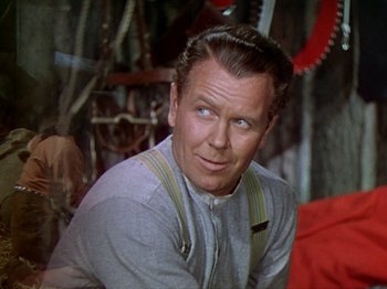 Movie still from “North West Mounted Police” (1940), directed by Cecil B. DeMille – An older man wearing suspenders sitting in a room; Close Up shot, Low angle