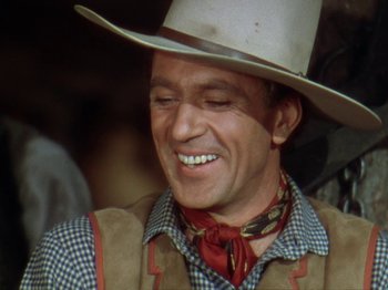 Movie still from “North West Mounted Police” (1940), directed by Cecil B. DeMille – A man wearing a cowboy hat and a vest; Close Up shot, Over the shoulder angle