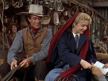 Movie still from “North West Mounted Police” (1940), directed by Cecil B. DeMille – A man and a woman in western garb; Medium shot, Over the shoulder angle