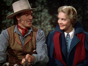 Movie still from “North West Mounted Police” (1940), directed by Cecil B. DeMille – A man and a woman holding hands while standing next to each other; Medium shot, Over the shoulder angle