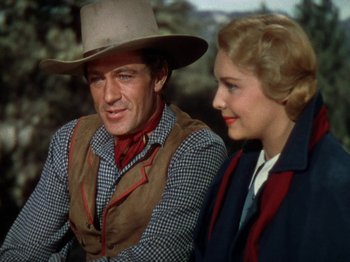 Movie still from “North West Mounted Police” (1940), directed by Cecil B. DeMille – A man and a woman sitting next to each other; Medium shot, Over the shoulder angle