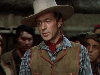 Movie still from “North West Mounted Police” (1940), directed by Cecil B. DeMille – A man wearing a cowboy hat and a vest; Medium shot, Low angle