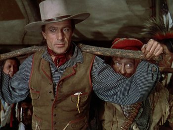 Movie still from “North West Mounted Police” (1940), directed by Cecil B. DeMille – A man and a woman holding on to a wooden stick; Medium shot, Low angle