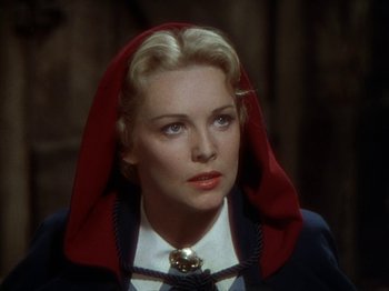 Movie still from “North West Mounted Police” (1940), directed by Cecil B. DeMille – A woman with a red hood on her head; Close Up shot, High angle