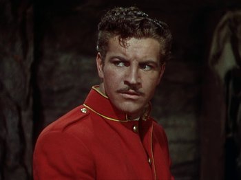 Movie still from “North West Mounted Police” (1940), directed by Cecil B. DeMille – A man in a red jacket and a mustache; Close Up shot, Low angle