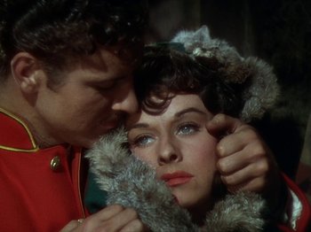 Movie still from “North West Mounted Police” (1940), directed by Cecil B. DeMille – A man and a woman are looking at each other; Close Up shot, High angle
