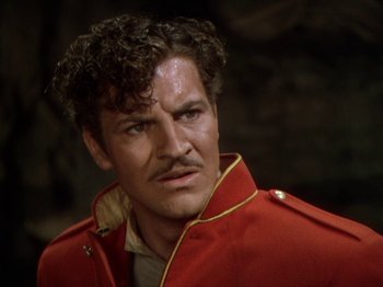 Movie still from “North West Mounted Police” (1940), directed by Cecil B. DeMille – A person wearing a red jacket; Close Up shot, Low angle