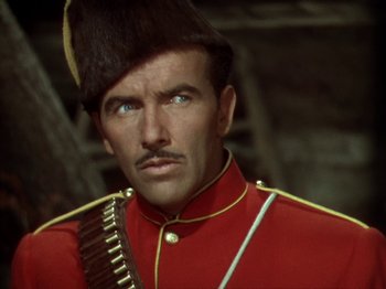 Movie still from “North West Mounted Police” (1940), directed by Cecil B. DeMille – A person wearing a uniform; Close Up shot, Over the shoulder angle
