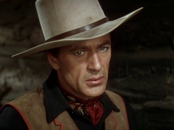 Movie still from “North West Mounted Police” (1940), directed by Cecil B. DeMille – A person wearing a cowboy hat; Close Up shot, Over the shoulder angle