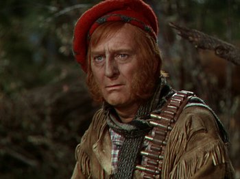 Movie still from “North West Mounted Police” (1940), directed by Cecil B. DeMille – A man with a red hat and a beard; Close Up shot, Low angle