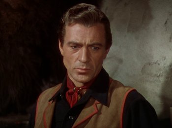 Movie still from “North West Mounted Police” (1940), directed by Cecil B. DeMille – A person wearing a suit and tie; Close Up shot, Over the shoulder angle