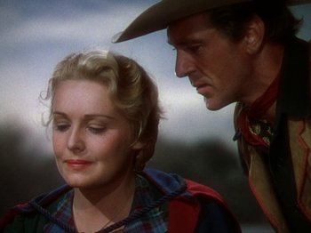 Movie still from “North West Mounted Police” (1940), directed by Cecil B. DeMille – A man and a woman standing next to each other; Close Up shot, Over the shoulder angle